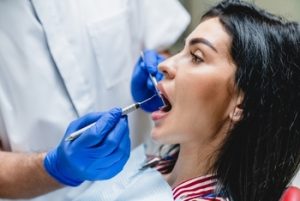 Beautiful,Caucasian,Woman,Visiting,Dentist,Orthodontist,,Whitening,Her,Teeth,,Filling