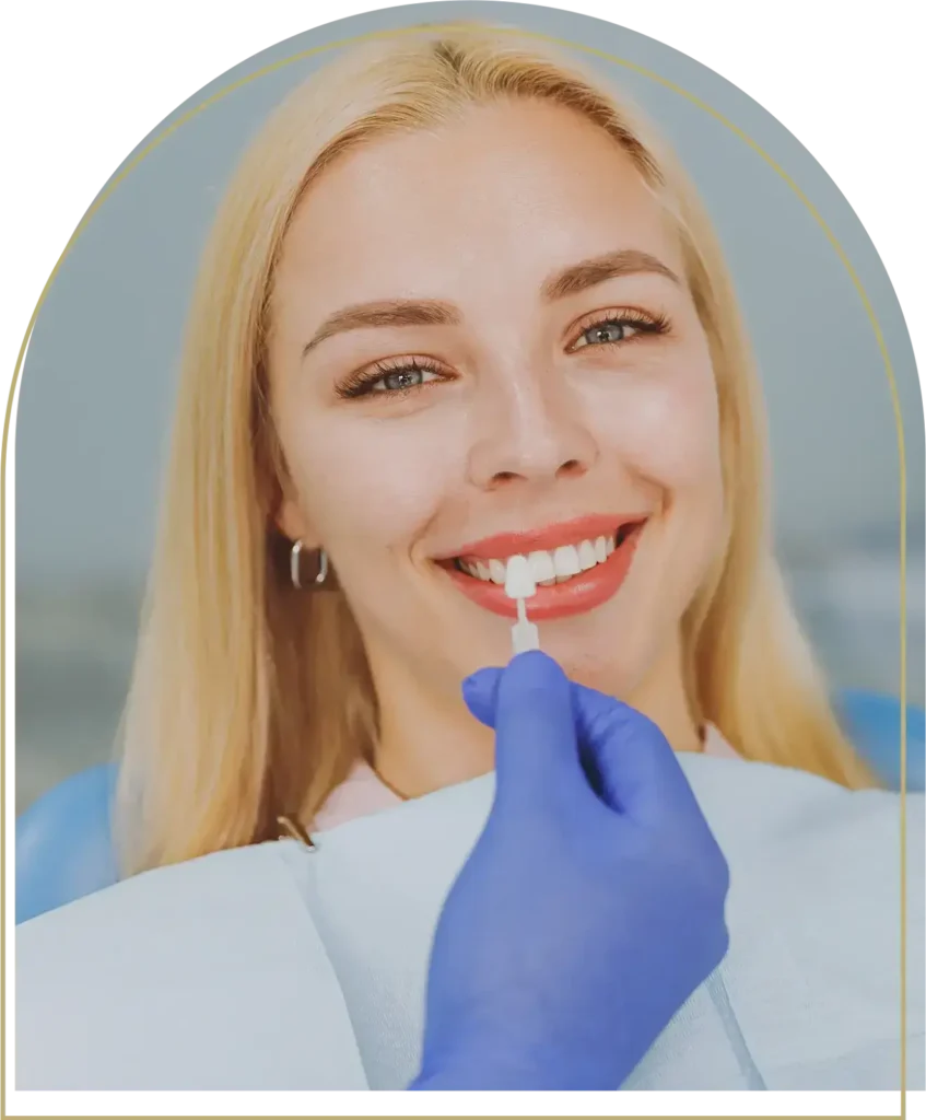 Dentist matching composite bonding shade to patient's natural teeth in Dubbo clinic.